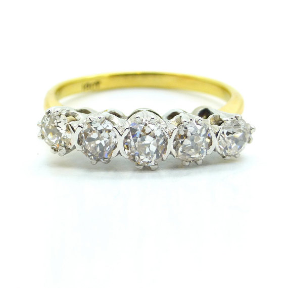 lovely gold ring with 5 mid sze diamonds which sit on a gold band